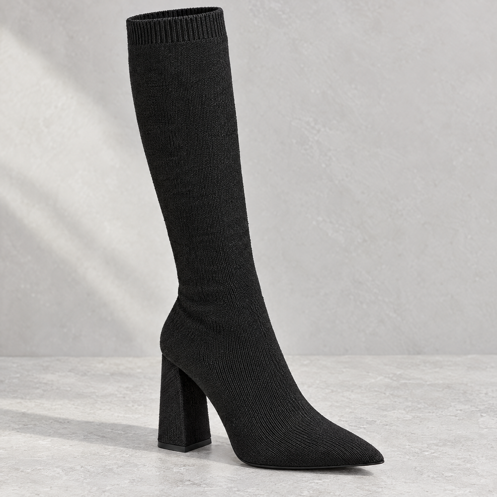 Close up of Marlowe black ribbed knit knee high sock boot showing knit texture and block heel