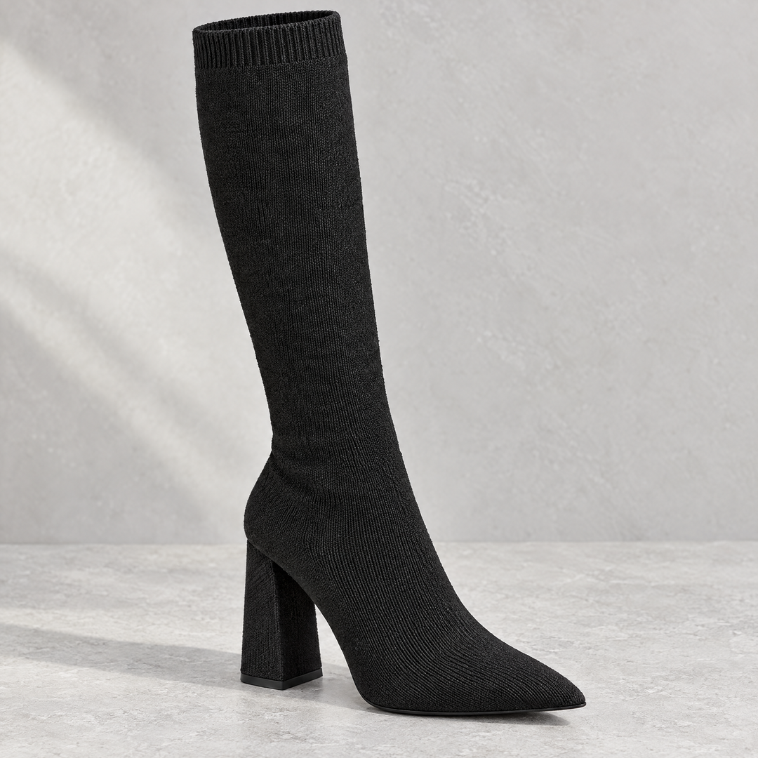 Close up of Marlowe black ribbed knit knee high sock boot showing knit texture and block heel