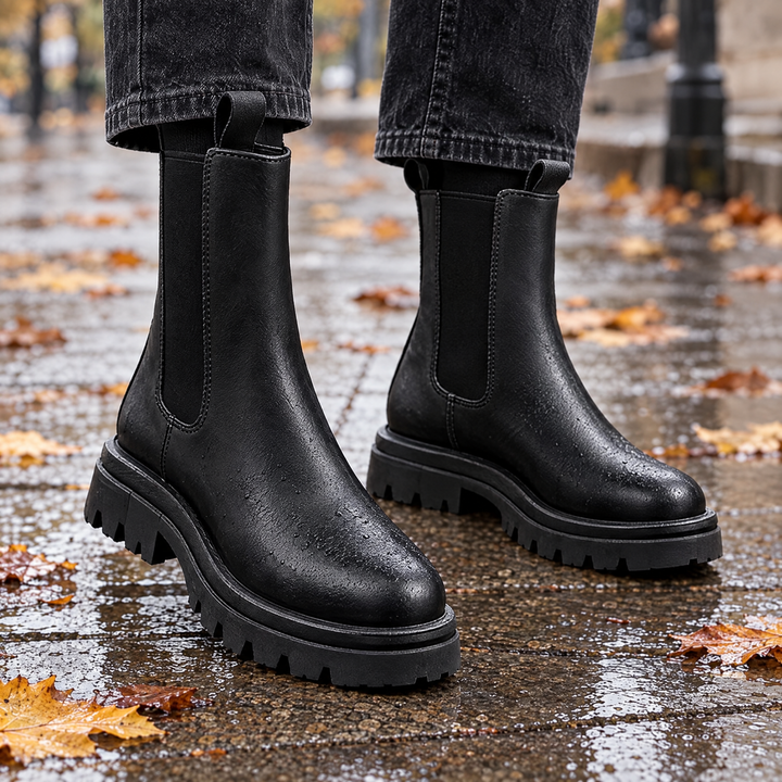 Sloane black chunky sole Chelsea boots on a wet city pavement