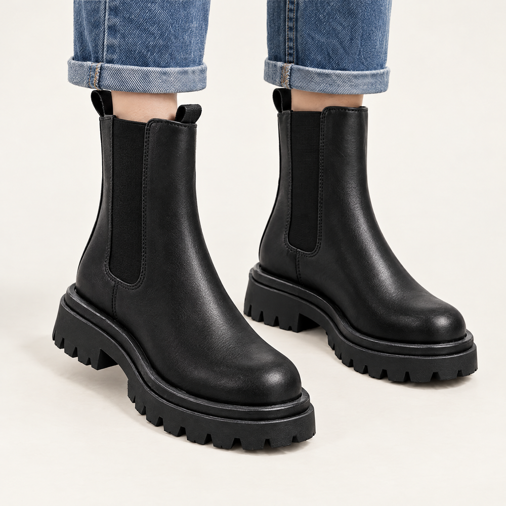 Sloane black chunky Chelsea boots worn with straight leg blue jeans