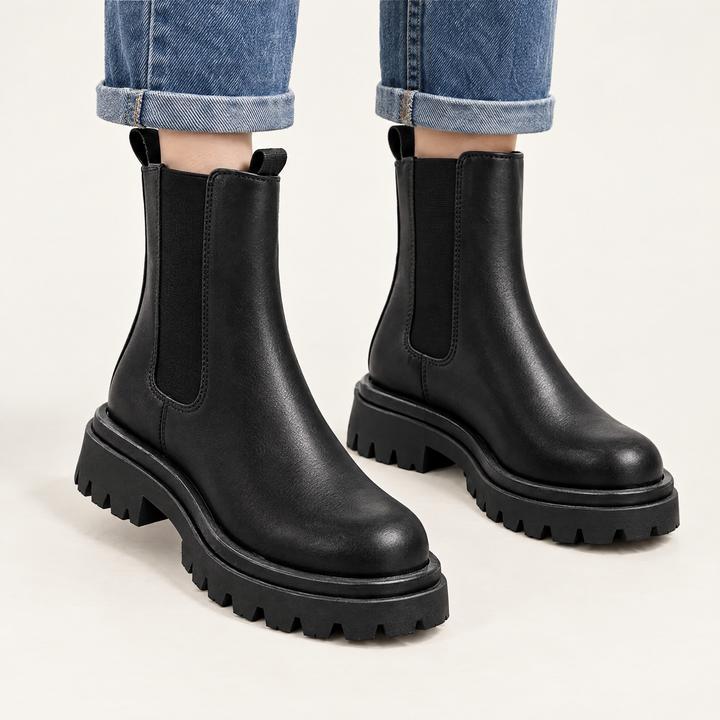 Sloane black chunky Chelsea boots worn with straight leg blue jeans